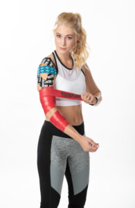 Image of fit woman in athleisure applying RockFloss over her RockTape kinesiology tape application